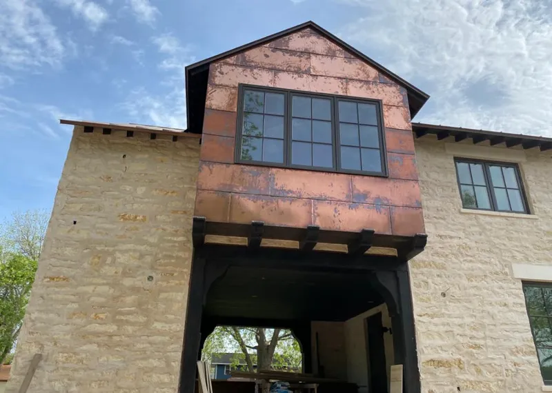 Copper metal panel facade on a stone building for Metal Roof Coating in Mango