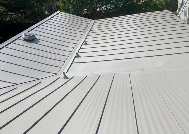 Solar attic fan installed on a metal roof for Roof Ventilation in Mango